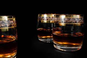 Glass of dark red whiskey, brandy or .bourbon