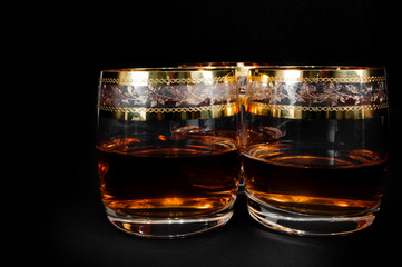 Glass of dark red whiskey, brandy or .bourbon