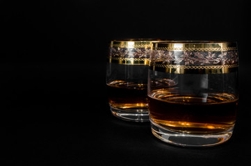 Glass of dark red whiskey, brandy or .bourbon