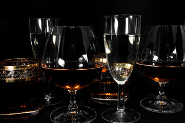 Glasses with different drinks brandy, whiskey, champagne or bourbon