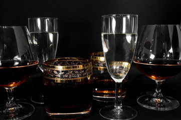 Glasses with different drinks brandy, whiskey, champagne or bourbon