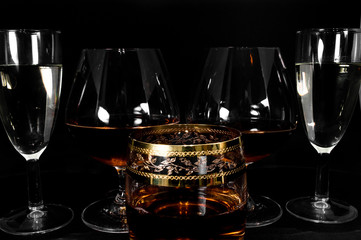 Glasses with different drinks brandy, whiskey, champagne or bourbon