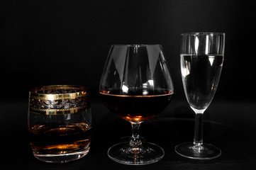 Glasses with different drinks brandy, whiskey, champagne or bourbon