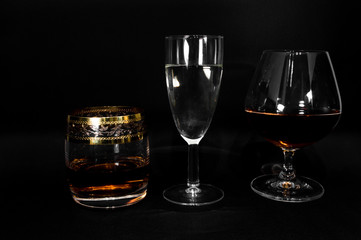 Glasses with different drinks brandy, whiskey, champagne or bourbon