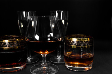 Glasses with different drinks brandy, whiskey, champagne or bourbon
