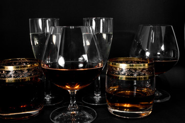 Glasses with different drinks brandy, whiskey, champagne or bourbon