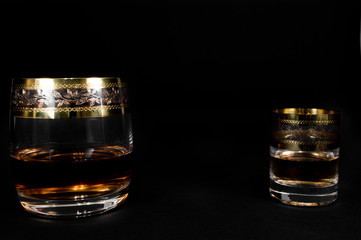 Short Glass and glass of dark red whiskey, brandy or .bourbon