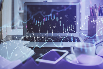 Forex market graph hologram and personal computer on background. Double exposure. Concept of investment.