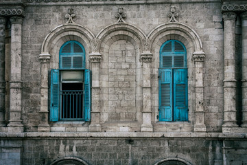 Fototapeta na wymiar Blue windows of the old house of the Templar Order
