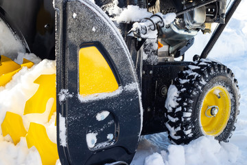 Wheel snow blower stands in a snowdrift