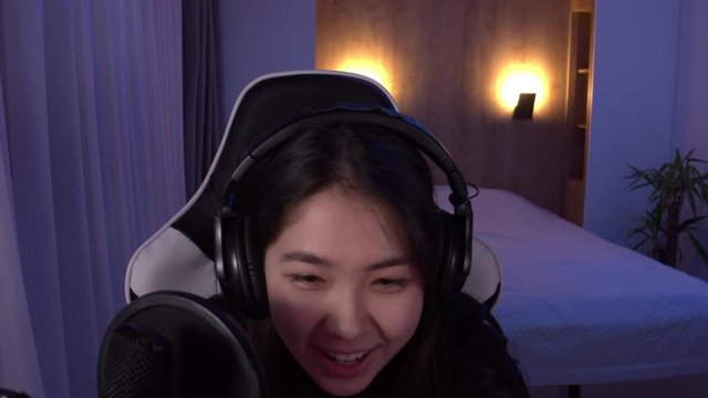 POV webcam view, Korean female gamer streamer winning a game while streaming online game from home. 4K UHD RAW graded footage