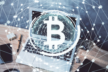 Double exposure of blockchain theme hologram and table with computer background. Concept of bitcoin crypto currency.