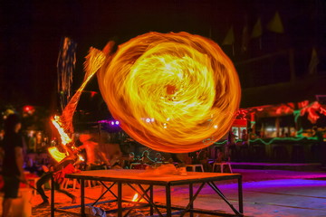 view of fantastic fire moving show on the beach, full moon party night life in Phi Phi islands,...