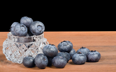 blueberry heap on dark wood background