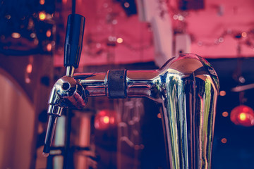 Tap of a draft beer machine shot in rose gold color tone to create a 1920's inspired look and theme