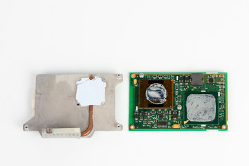 Cooler and circuit of laptop processor with thermal paste on white background