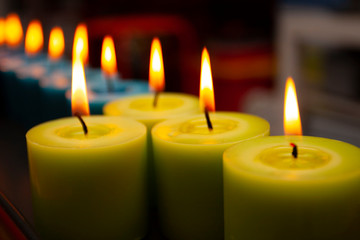 blue and green candles burning in the dark