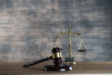 Law and Justice concept. Mallet of the judge, books, scales of justice. Gray stone background,...