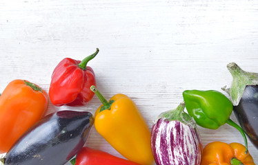 collection of colorful vegetables as peppers and eggplants on a white table  with copy space