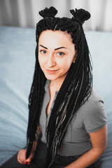 Portrait of a beautiful cool girl with Senegalese pigtails twists very cool