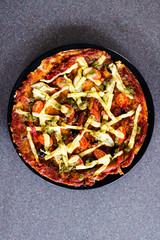 homemade vegetables pizza with vegan cheese olives and cherry tomatoes topping