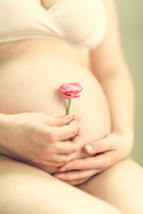 Happy expectant mother with flower