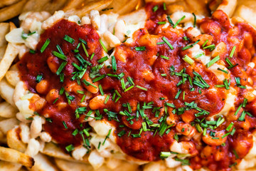 plant-based recipes, close-up of oven baked chips with beans and tomato sauce toppig