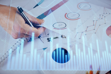 Multi exposure of man planing investment with stock market forex chart.