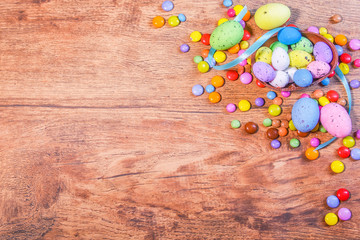 Easter composition with chocolate eggs on  wooden background