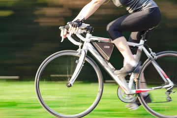 Naklejka na ściany i meble Riding bicycle - blurred motion, fast driving.