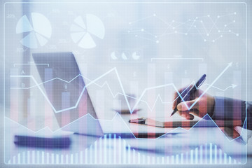 Multi exposure of forex chart with man working on computer on background. Concept of market analysis.