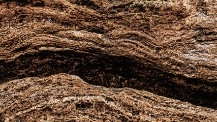 Different texture on the beach - water and sand, stones and pebbles, waves and splashes.