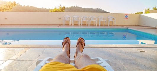 Enjoying summer time vacation near the swimming pool.