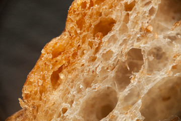 Macro of bread slice. Brown bakery food, loaf with grains.