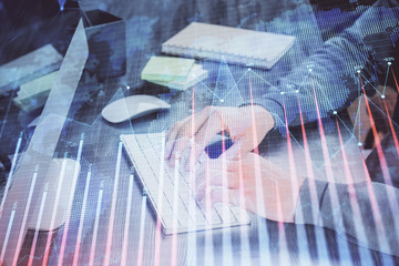 Stock graph with businessman typing on computer in office on background. Concept of analysis....