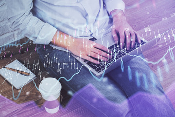 Forex graph with businessman working on computer in office on background. Concept of analysis....