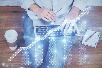 Forex graph with businessman working on computer in office on background. Concept of analysis....