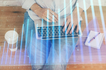 Forex graph with businessman working on computer in office on background. Concept of analysis....