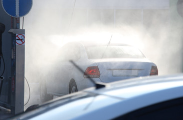 Car in spray of water at a self-service car wash