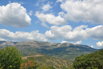 Fototapeta na wymiar Beautiful clouds on a blue sky in the mountains. Crimean mountains
