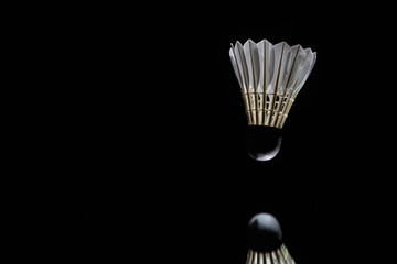 Badminton shuttlecock in a black background used in competition