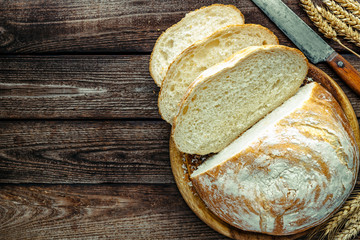 loaf of bread on wooden background, food closeup.Fresh homemade bread.French bread. Bread at...