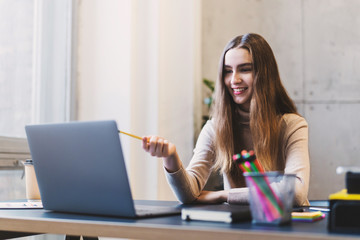 Millennial woman learning information from internet. Girl preparing for seminar online, taking web course, doing research. Female company executive working on creative project using digital device