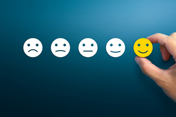 Customer service evaluation and satisfaction survey concepts. The client's hand picked the happy...