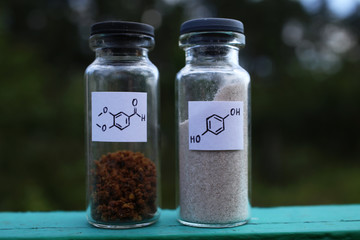 Two glass jars with interesting organic substances, aromatic aldehyde and hydroquinone, for the...