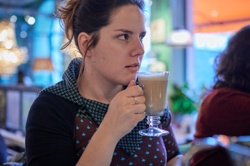 Young woman enjoying a cup of cofe on a rainy day. Coffee break. Enjoying the coffee aroma.