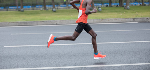 Fototapeta premium Marathon runner running on the race on city road