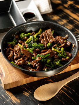 Beef meat and broccoli vegetable cooking in pan close up, selective focus. Traditional food recipe.