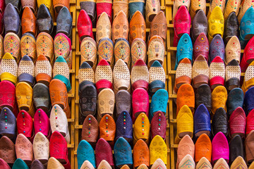 Colorful Babouche slippers - Traditional Moroccan footwear at the bazaar in Marocco - obrazy, fototapety, plakaty