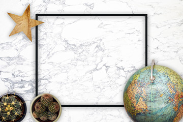 Flat lay top view World travel concept with marble background and black frame
